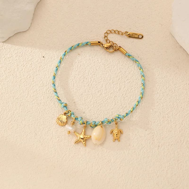 Bracciale con charms stella marina e conchiglia su cordino