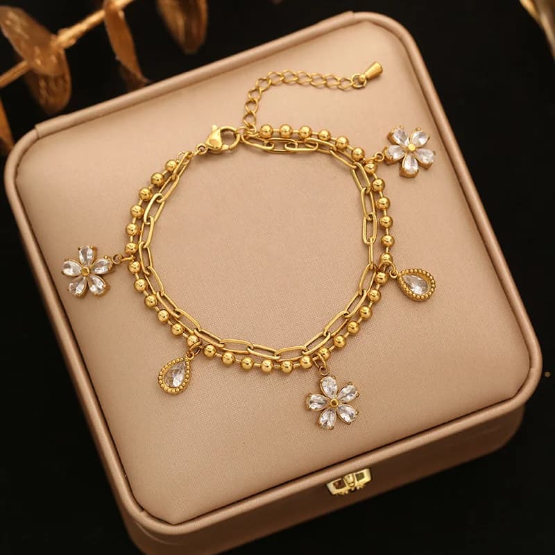 Braccialetto charm fiore e stella con perle