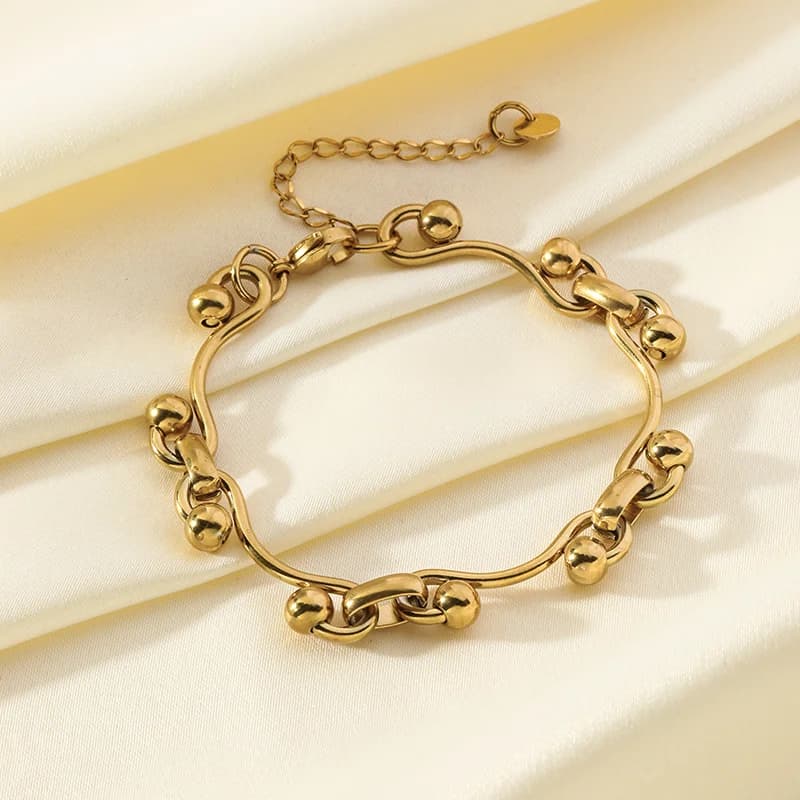 Bracciale rigido in acciaio inox 316L con ciondolo a cuore color oro