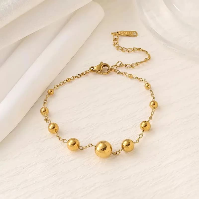 Bracciale rigido a catena con sfere dorate