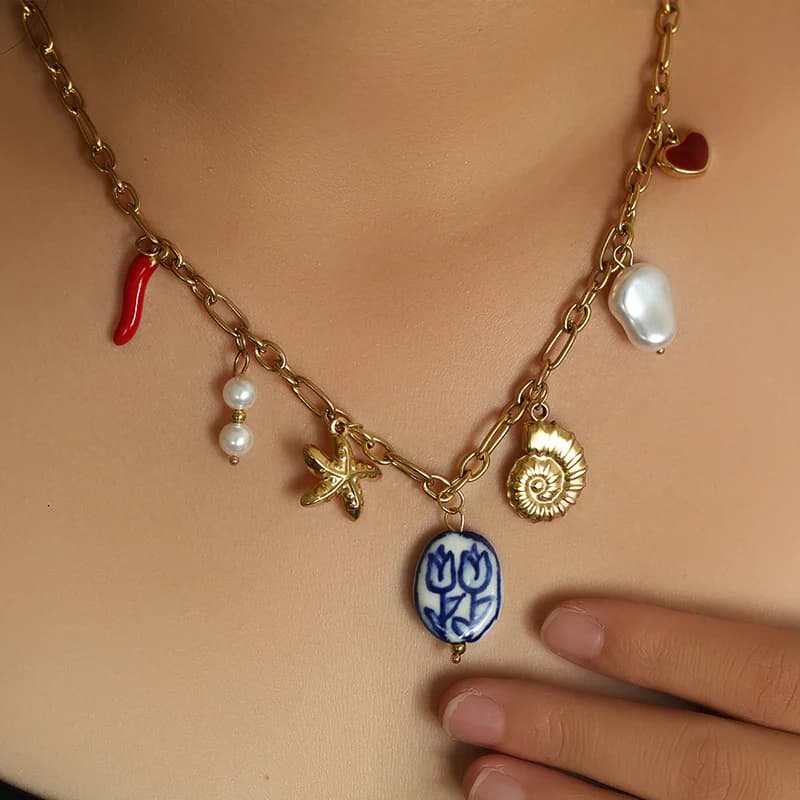 Collana pendente oro con stella marina, conchiglia e sole