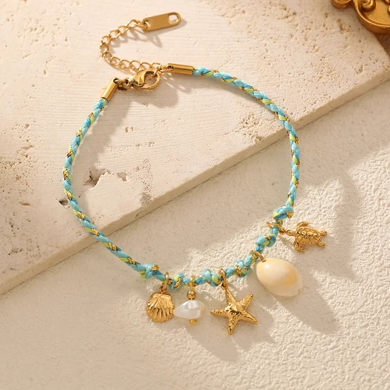 Bracciale con charms stella marina e conchiglia su cordino
