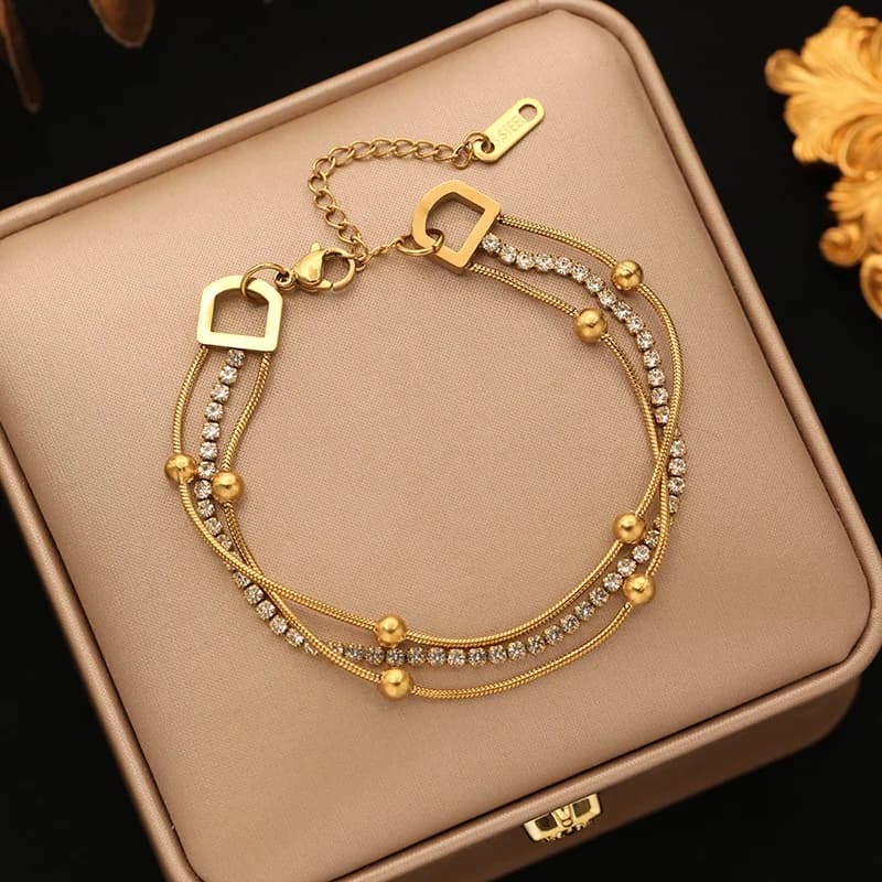 Bracciale rigido a catena con sfere dorate