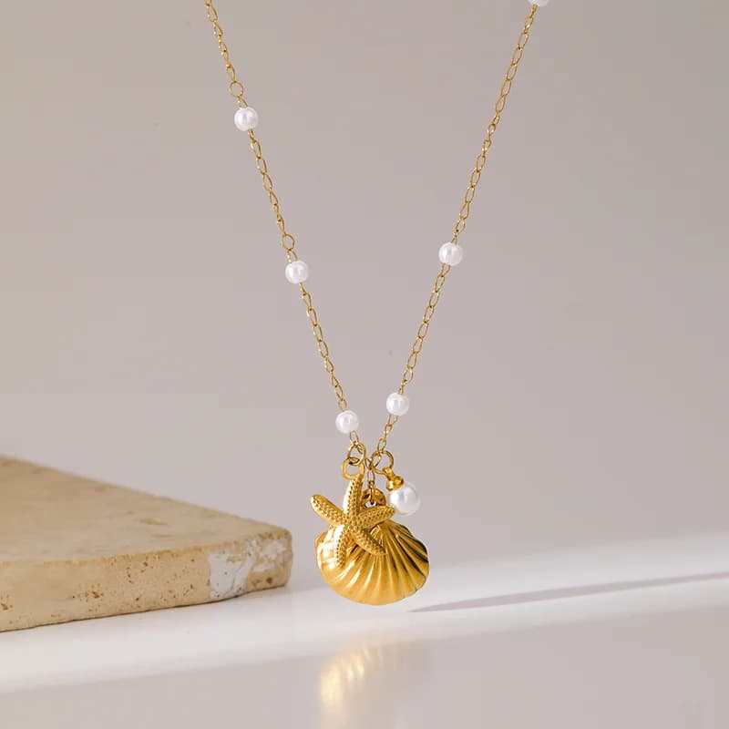 Collana pendente stella marina conchiglia e perla in acciaio inox