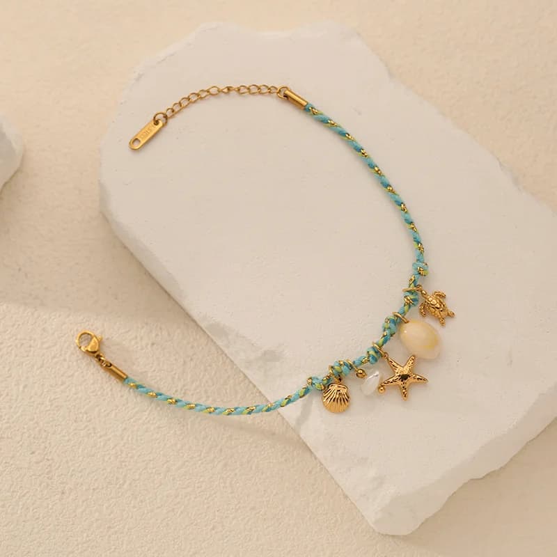 Bracciale con charms stella marina e conchiglia su cordino